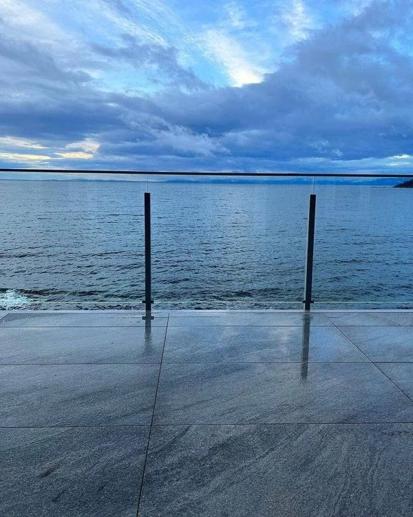 Waterfront deck framework on adjustable pedestals