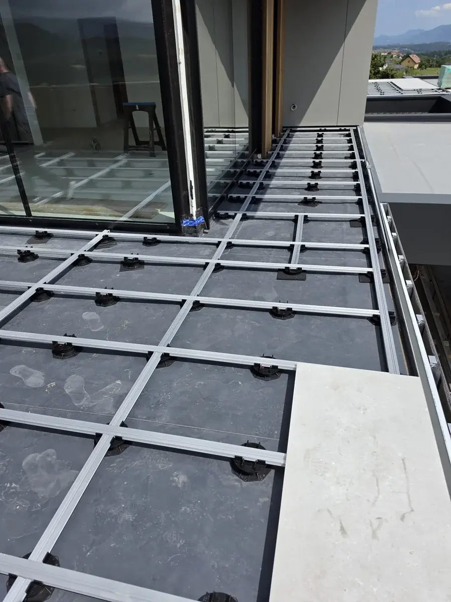 Pedestal grid continuing flush through the large sliding door track at a Slovenia mansion rooftop