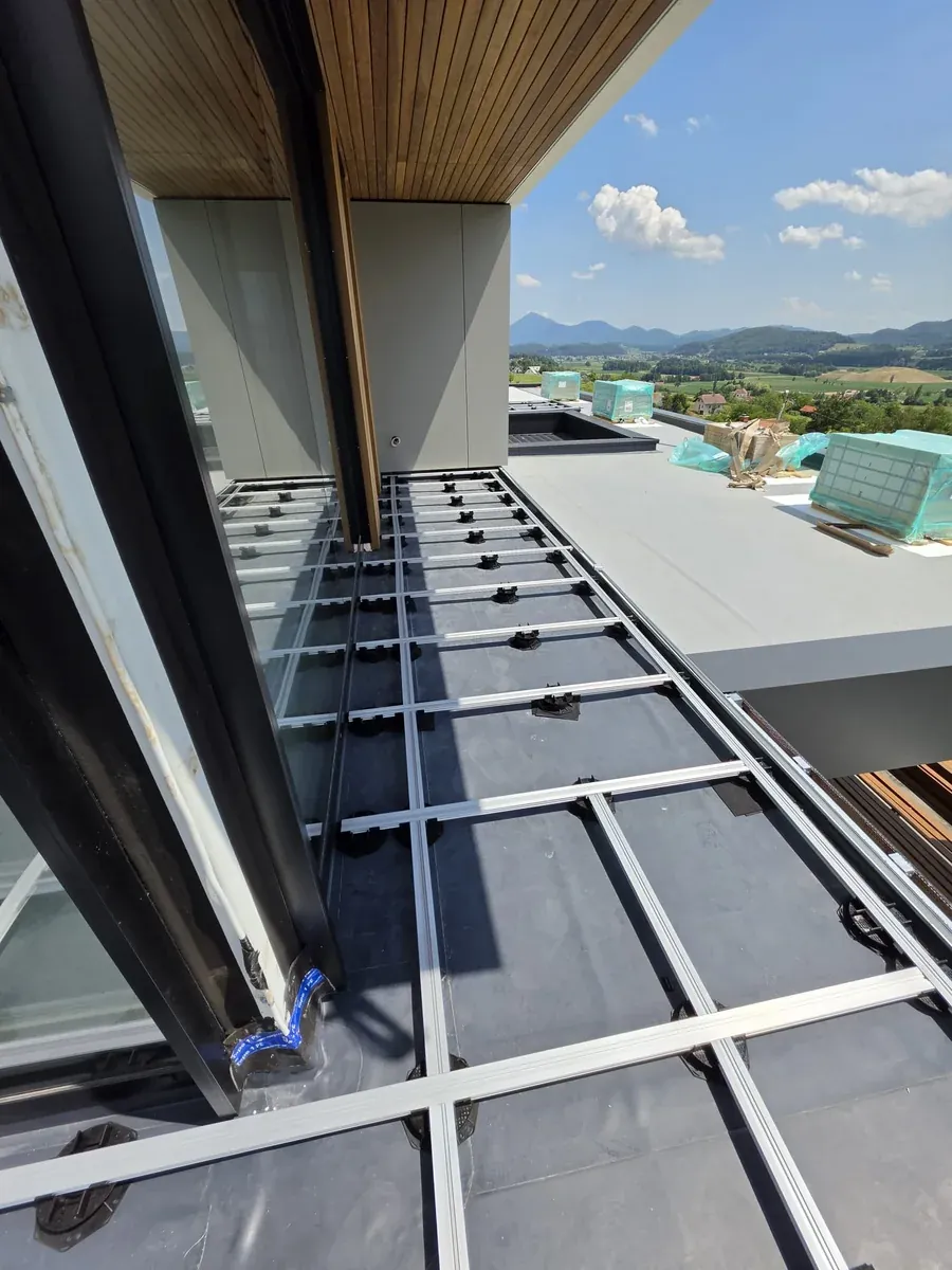 Wrapped paver pallets staged on the finished membrane at a Slovenia mansion rooftop