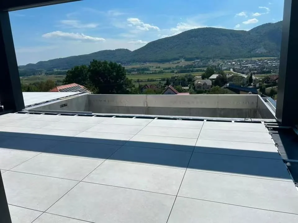 Finished porcelain terrace surface laid on adjustable pedestals at a Slovenia mansion rooftop